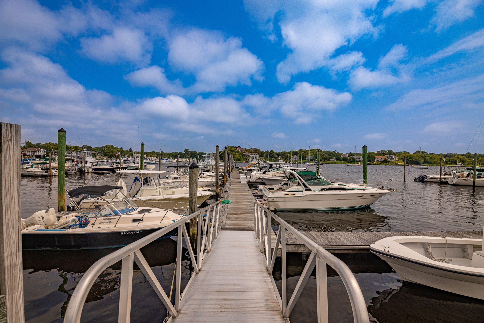 Boats are docked at a marina on a sunny day