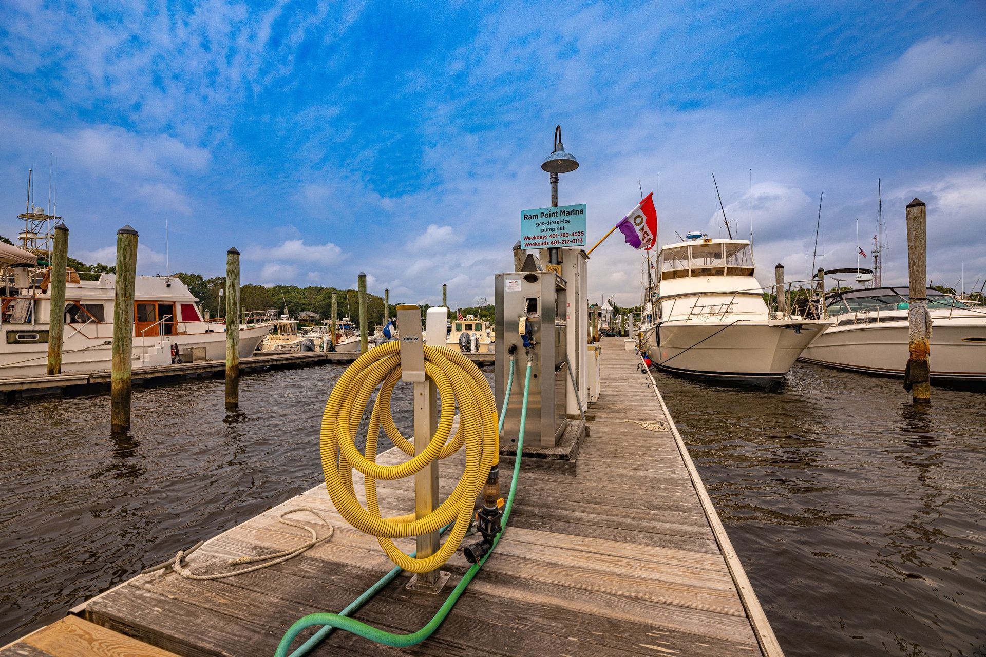 A yellow rope is tied to a dock at a marina.