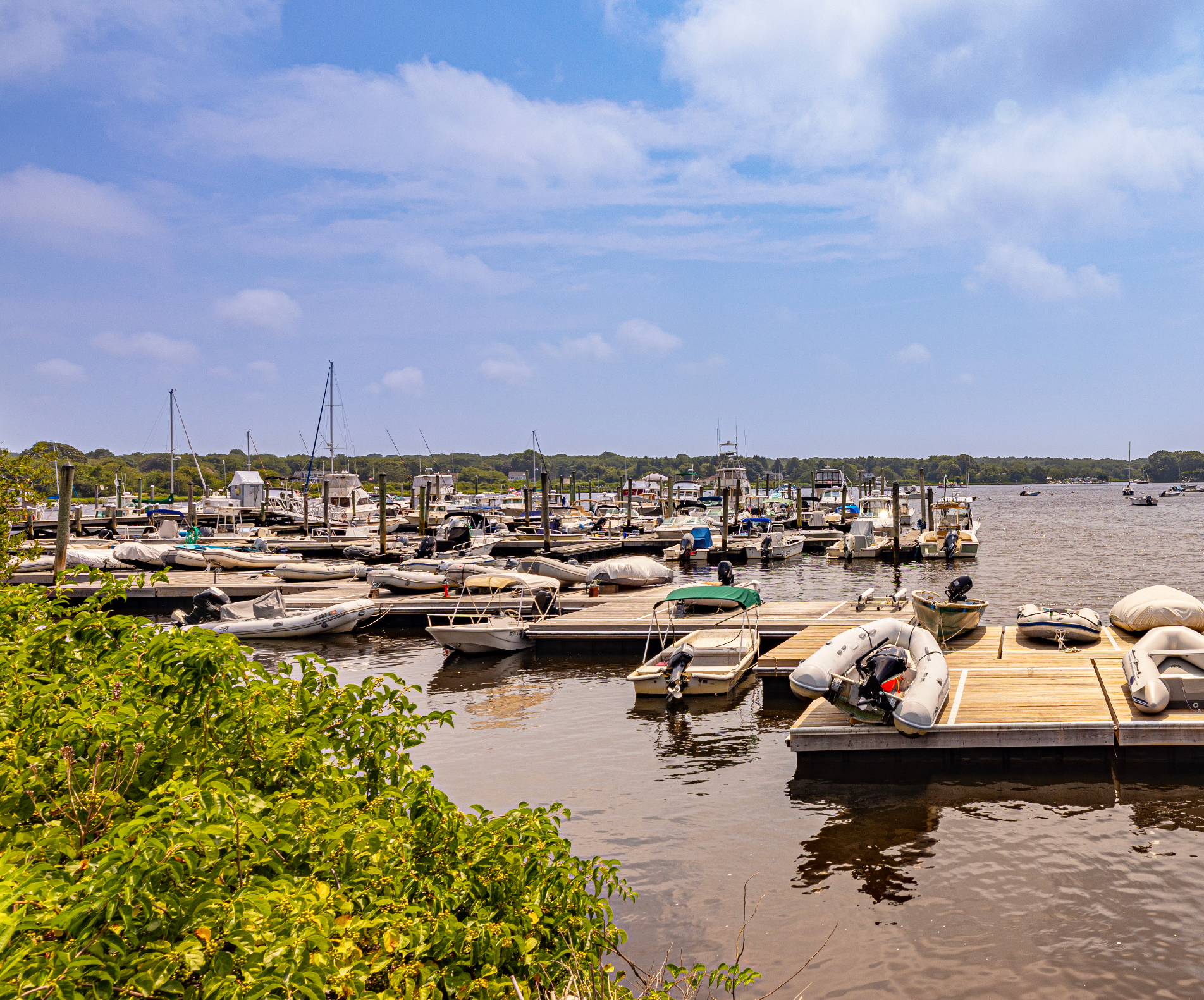 A marina filled with lots of boats on a sunny day.
