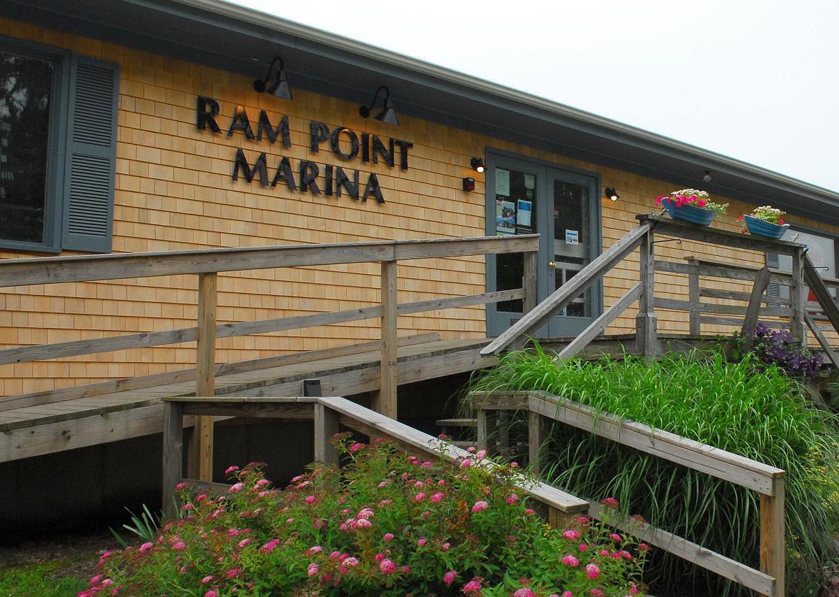 A ram point marina building with flowers in front of it