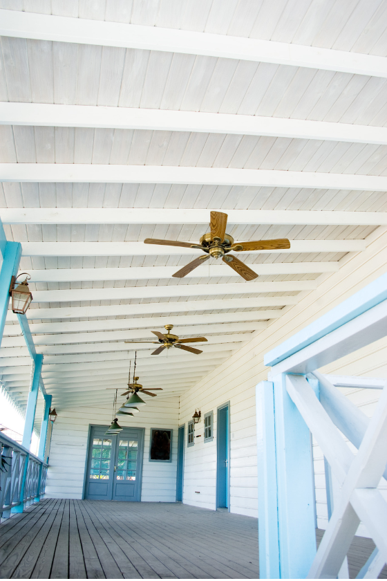 A hallway with ceiling fans hanging from the ceiling