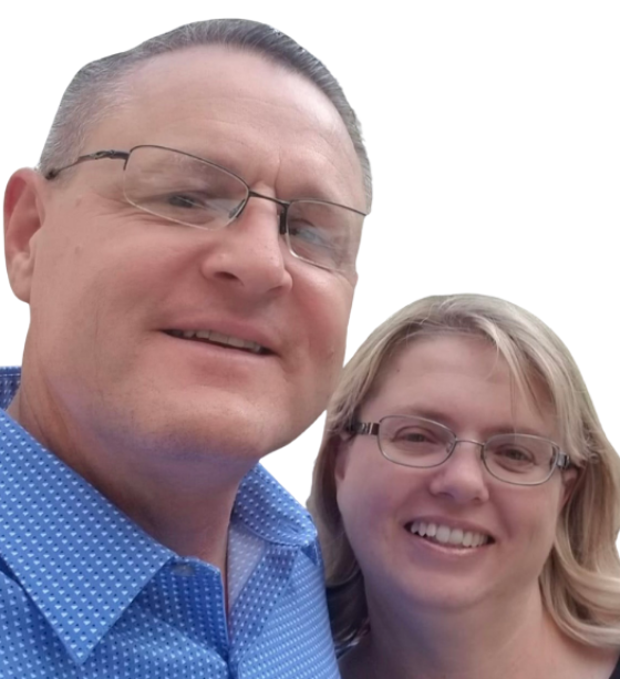 A man and a woman are posing for a picture and the man is wearing glasses