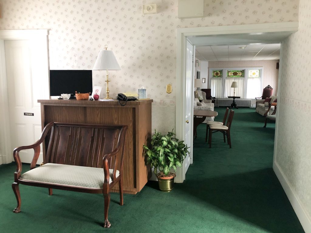 A room with a couch and a desk in it