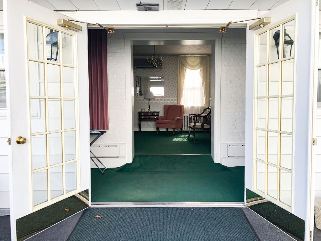 A room with a green carpet and white doors