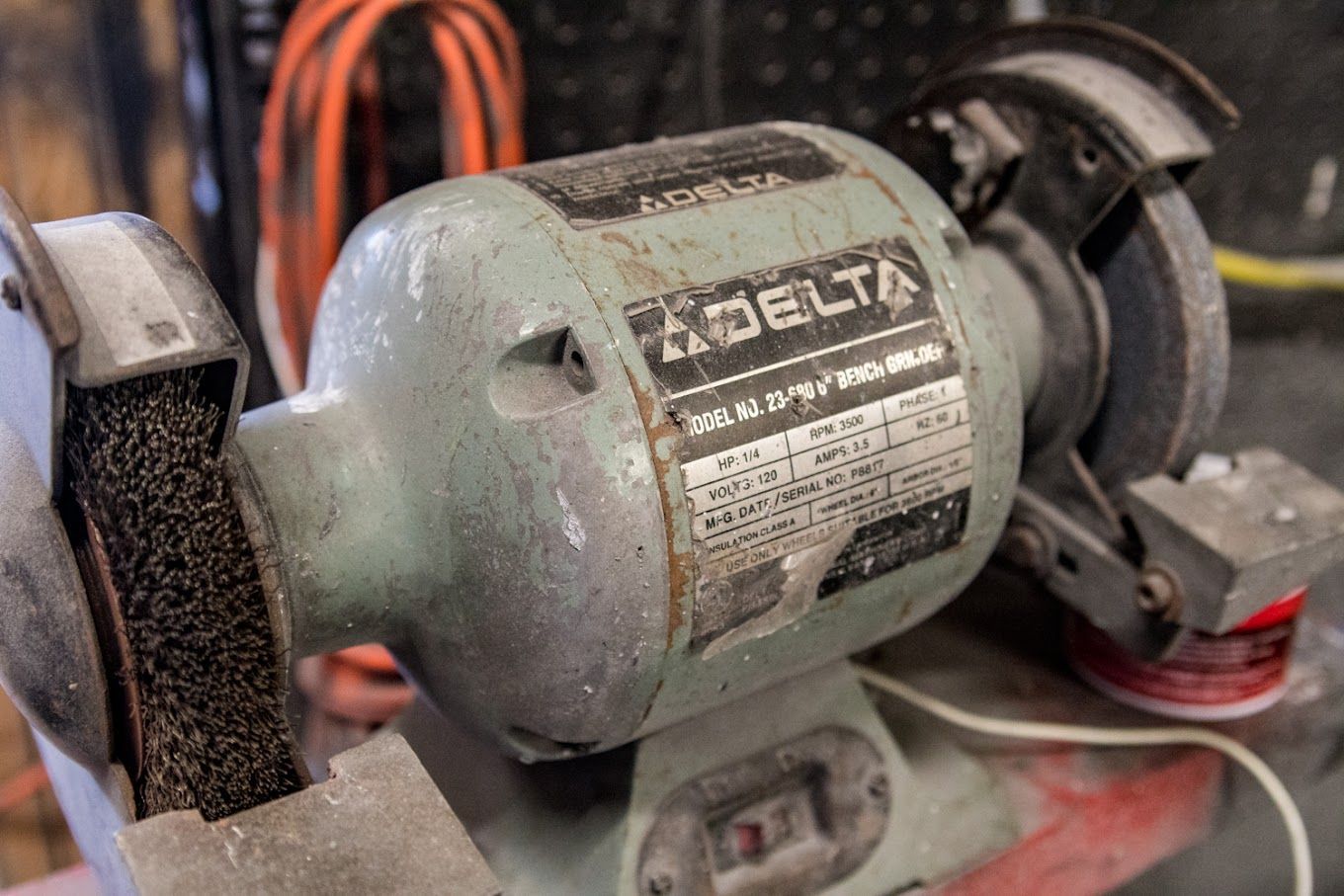 A delta bench grinder is sitting on a table.