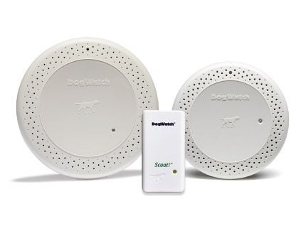 Two smoke detectors and a remote control are sitting next to each other on a white surface.