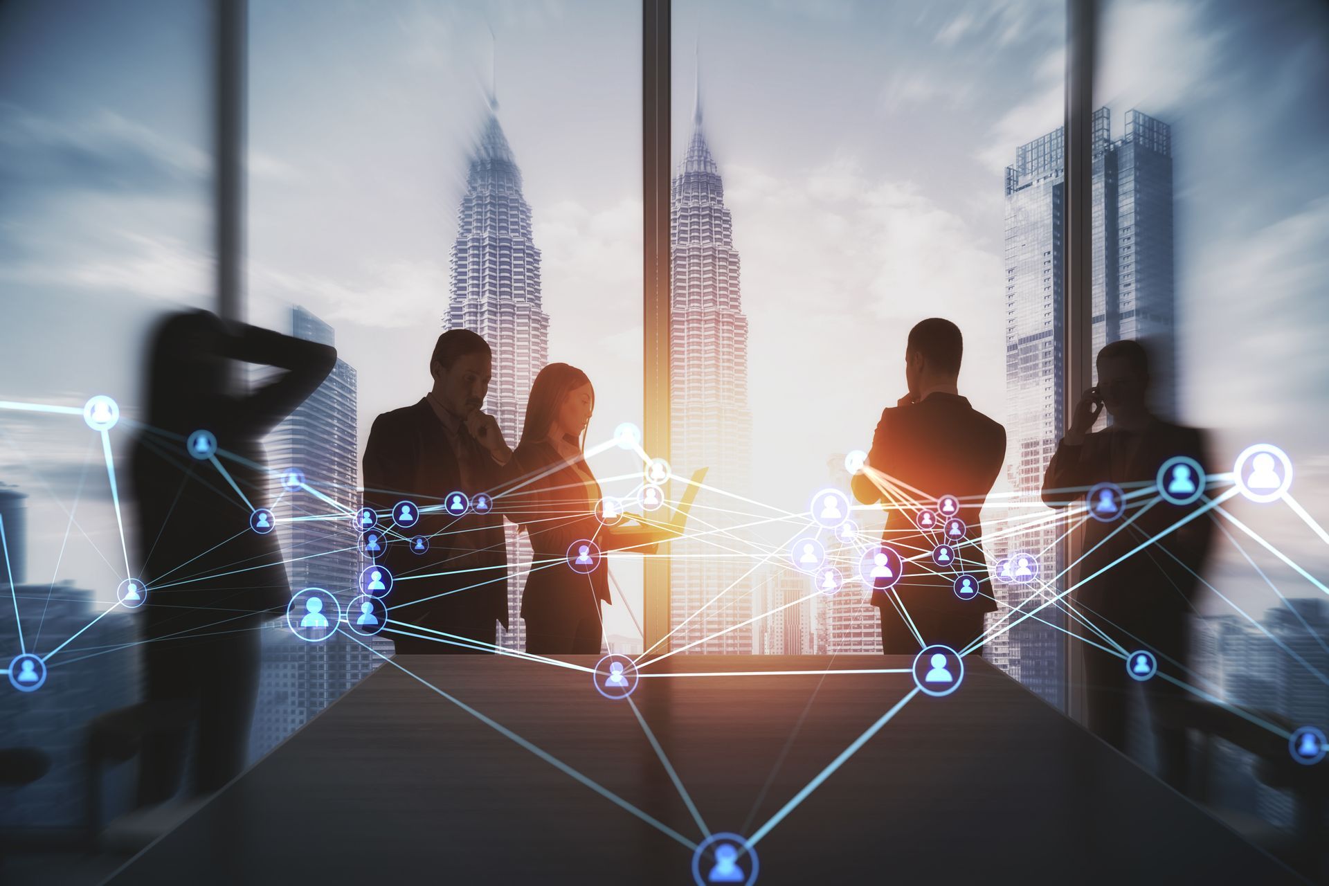 Businesspeople silhouetted by a cityscape, collaborating around a table. Digital network overlay.