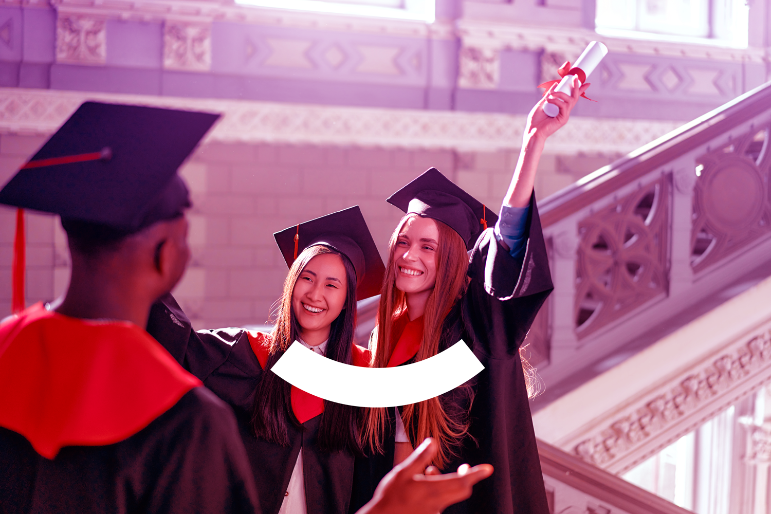 A man is sitting at a desk looking at a computer screen.