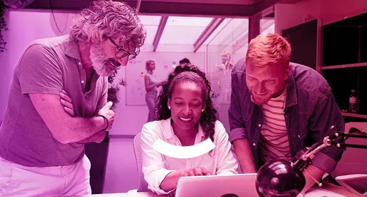 A group of people are looking at a laptop computer.
