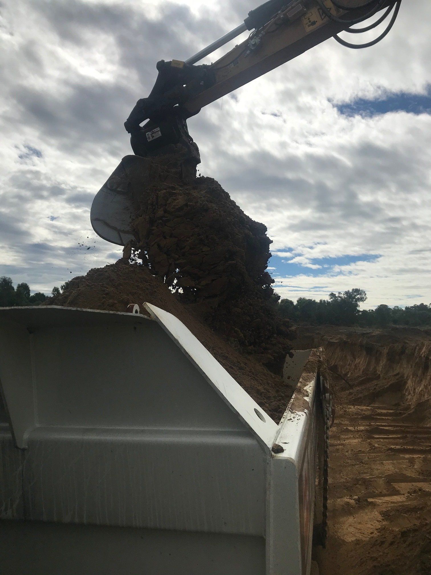 Yellow Excavator At A Construction Site — K & T Daley in Rockhampton, QLD
