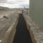 Excavator Land With Black Mat — K & T Daley in Gracemere, QLD