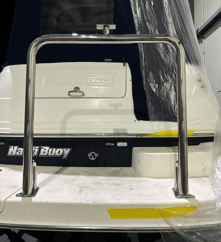 Stern of a White Boat With a Metal Safety Rail — Master Metals Fabrication in Labrador, QLD