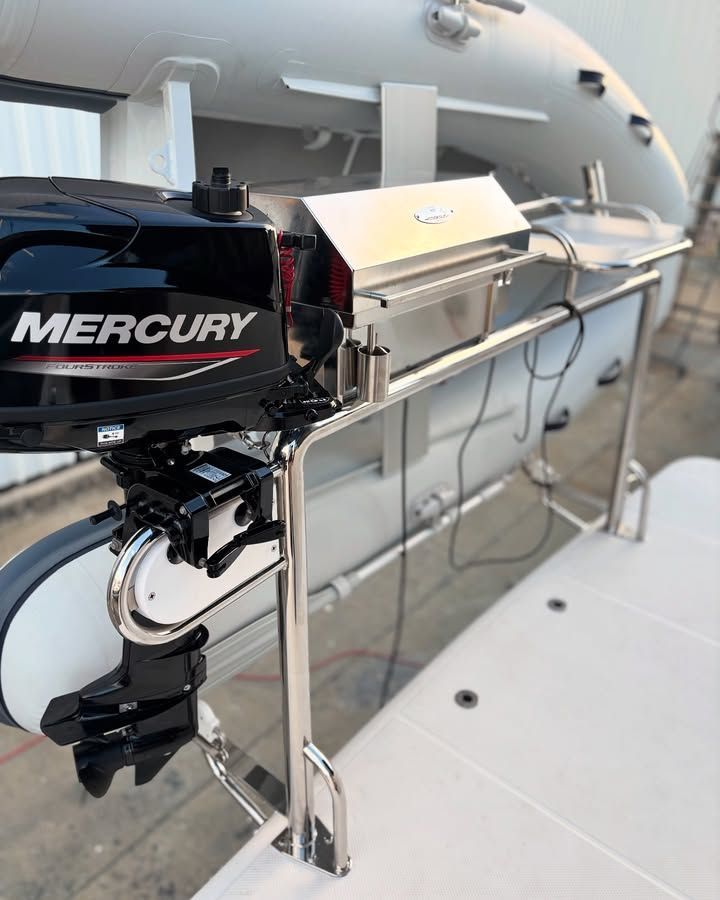 A Stainless Steel Grill Mounted on a Boat With a Mercury Outboard Motor — Master Metals Fabrication in Labrador, QLD
