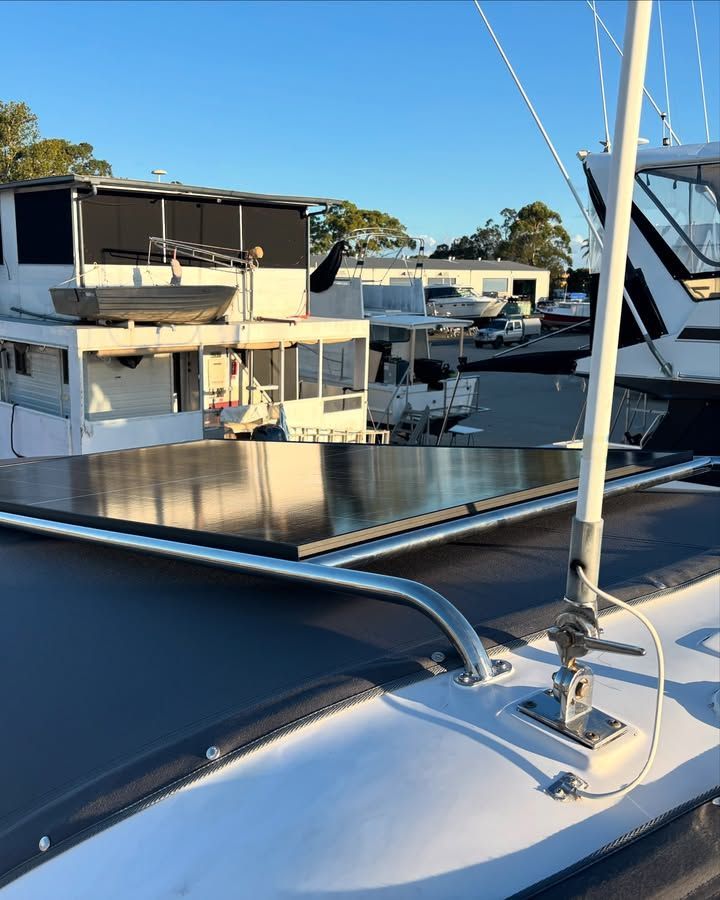 Boat Deck With Solar Panels, a Mast, and Buildings in the Background — Master Metals Fabrication in Labrador, QLD