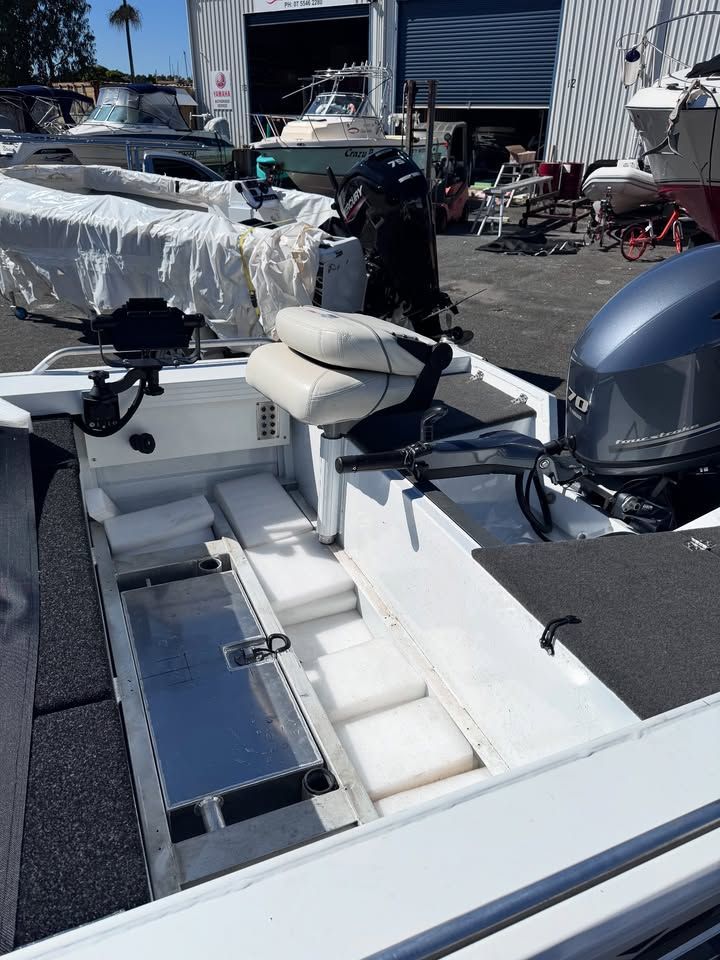 White Fishing Boat With a Motor, Interior View of Seats and Storage Compartments — Master Metals Fabrication in Labrador, QLD