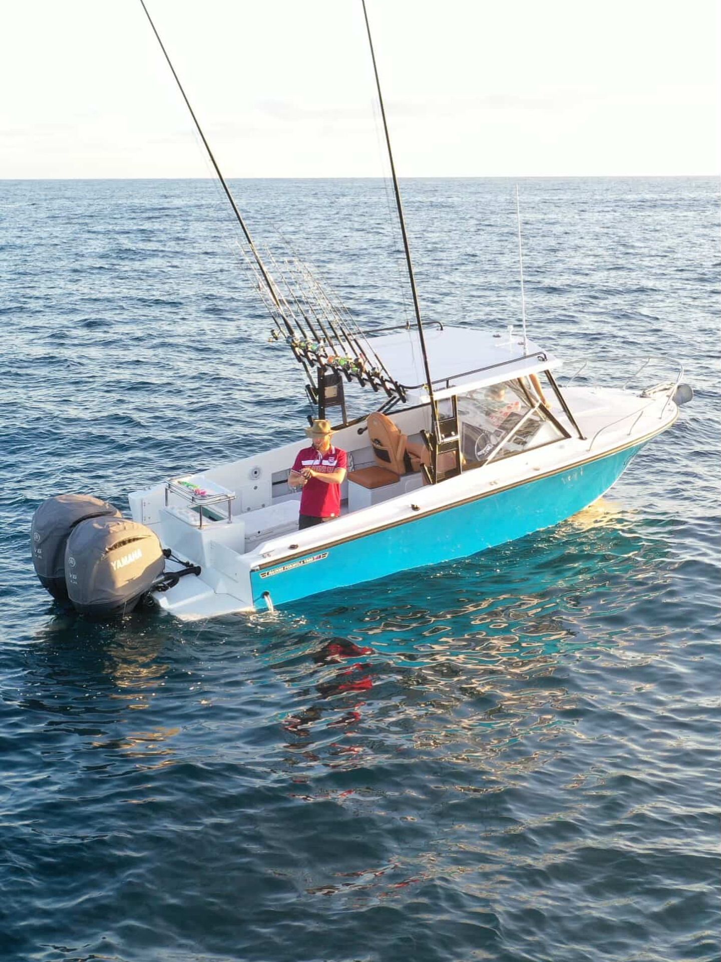 Fishing Boat on Water With Person Standing Inside — Master Metals Fabrication in Labrador, QLD