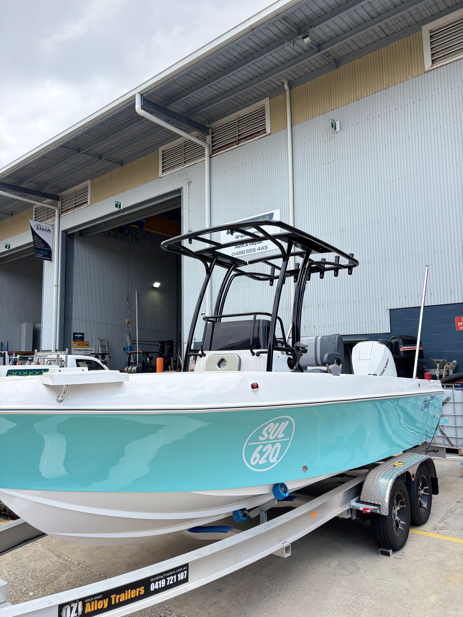 Boat With Stainless Steel Railing and a Blue Cooler on Deck, Blue Sky Background — Master Metals Fabrication in Labrador, QLD