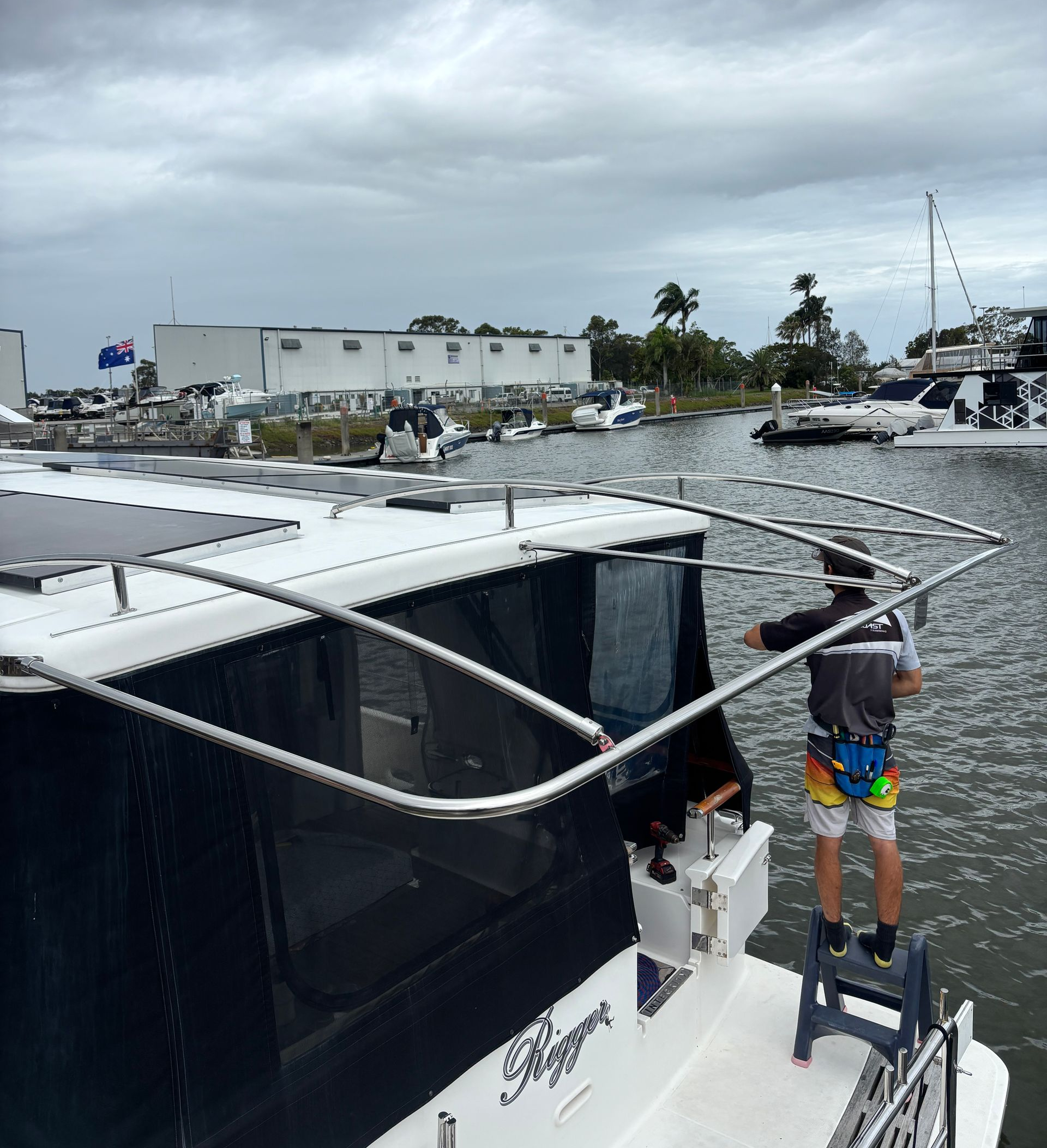 White Yacht Stern With Chrome Fishing Rod Holders Against a Bright Sky — Master Metals Fabrication in Labrador, QLD