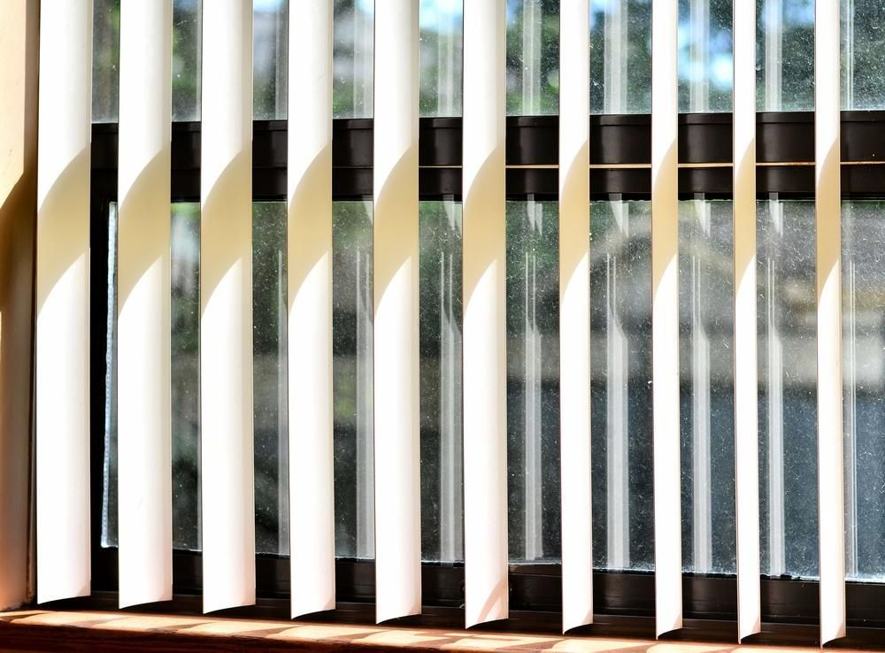 Vertical Blinds on a Window, Casting Shadows. Sunlight Streams Through — My Timber Flooring Blinds & Shutters in Erina, NSW