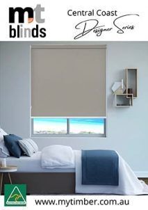 Bedroom With Closed Beige Roller Blind, Bed With Blue Blanket, Window View. Central Coast Designer Series — My Timber Flooring Blinds & Shutters in Erina, NSW