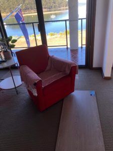 Red Armchair Inside — My Timber Flooring Blinds & Shutters in Erina, NSW