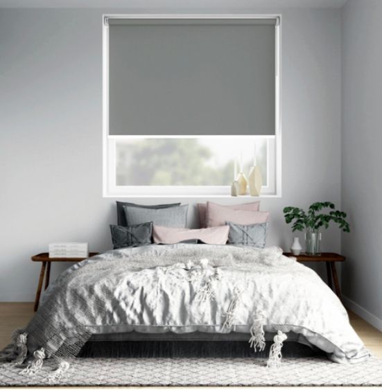 Bedroom With Gray Roller Shade Over a Window, Bed With Pillows, and Small Side Tables — My Timber Flooring Blinds & Shutters in Erina, NSW