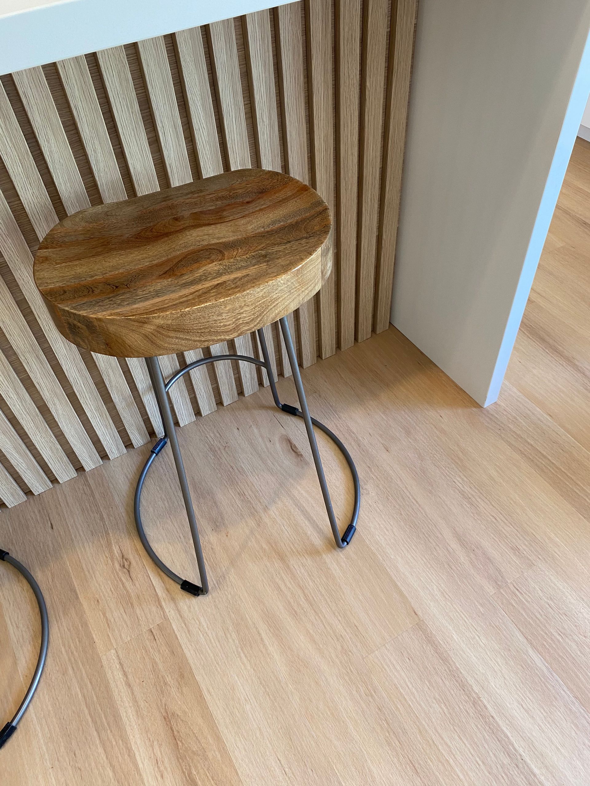 Wooden Stool With Metal Legs on a Light Wood Floor, Near a Textured Wall — My Timber Flooring Blinds & Shutters in Erina, NSW