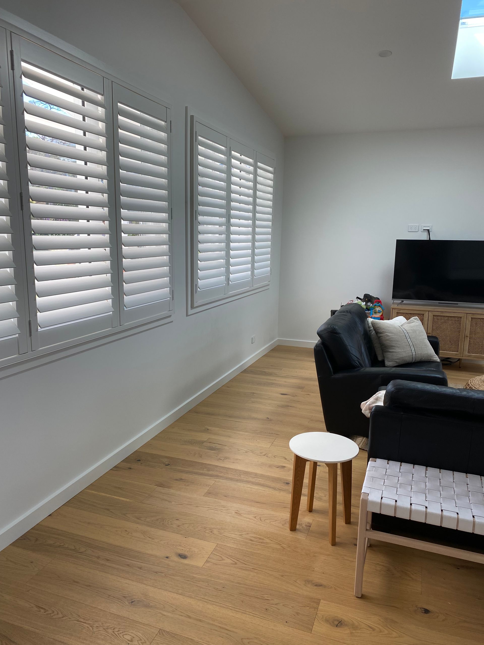 Red Armchair With a Blanket, Next to a Light Wood Board, Overlooking a Lake View — My Timber Flooring Blinds & Shutters in Erina, NSW