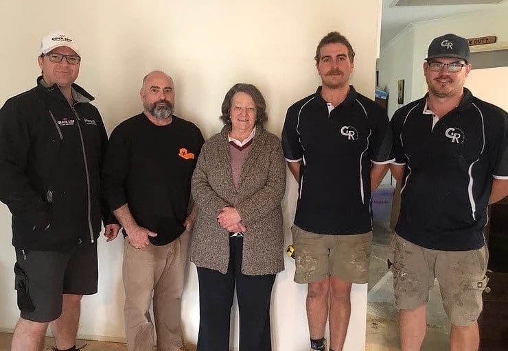 Five People Stand Against a Wall. Two Men in Work Attire Flank — My Timber Flooring Blinds & Shutters in Erina, NSW