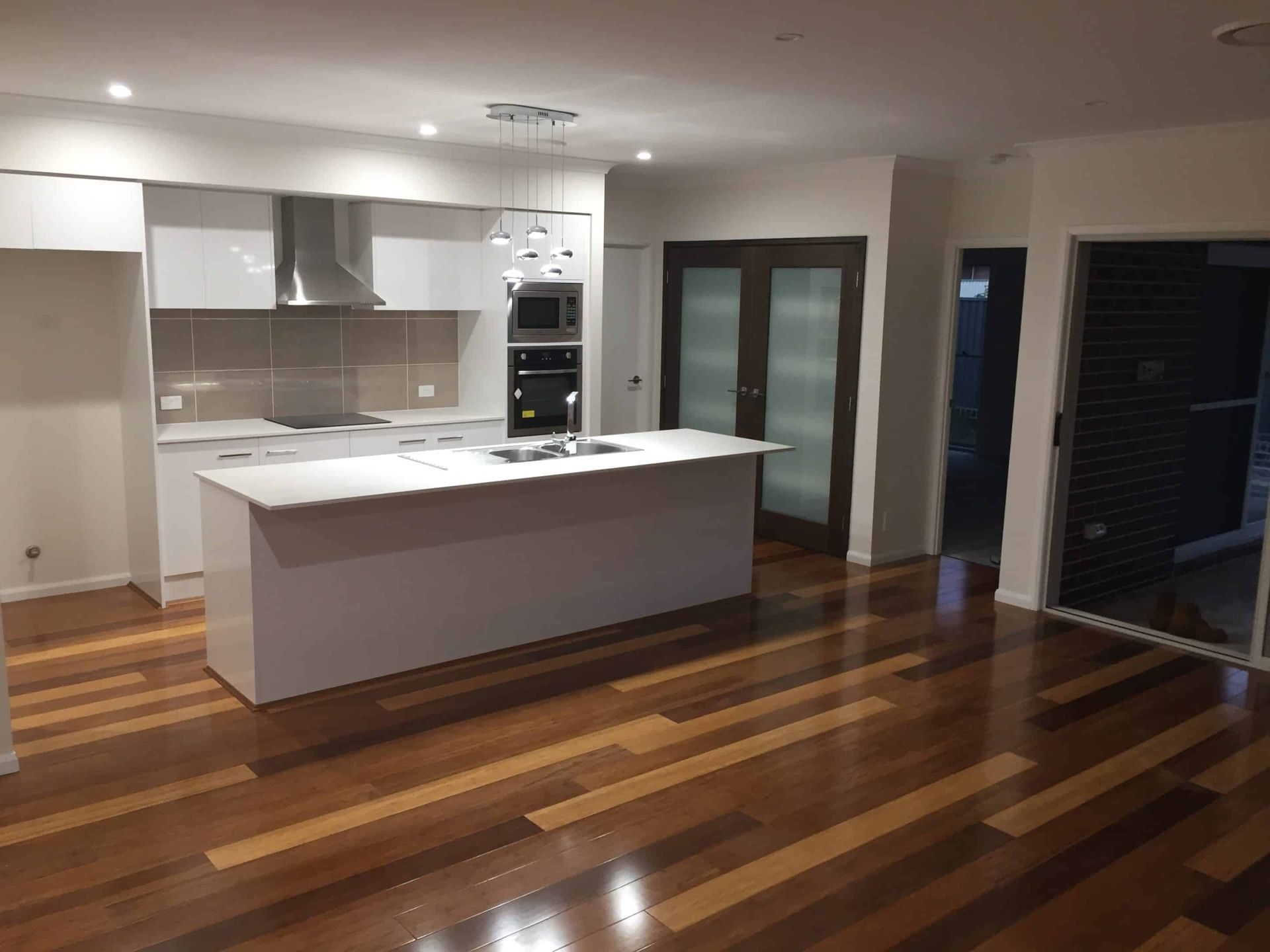 Modern Kitchen with White Cabinetry, Island — My Timber Flooring Blinds & Shutters in Erina, NSW