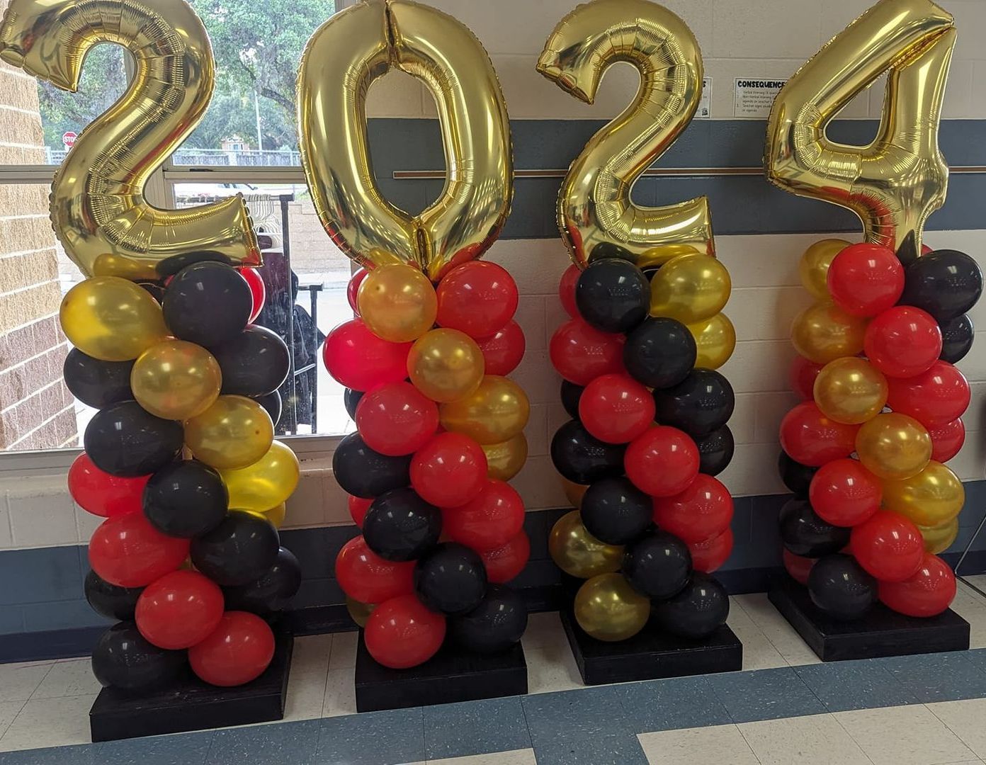 Four balloon columns spelling