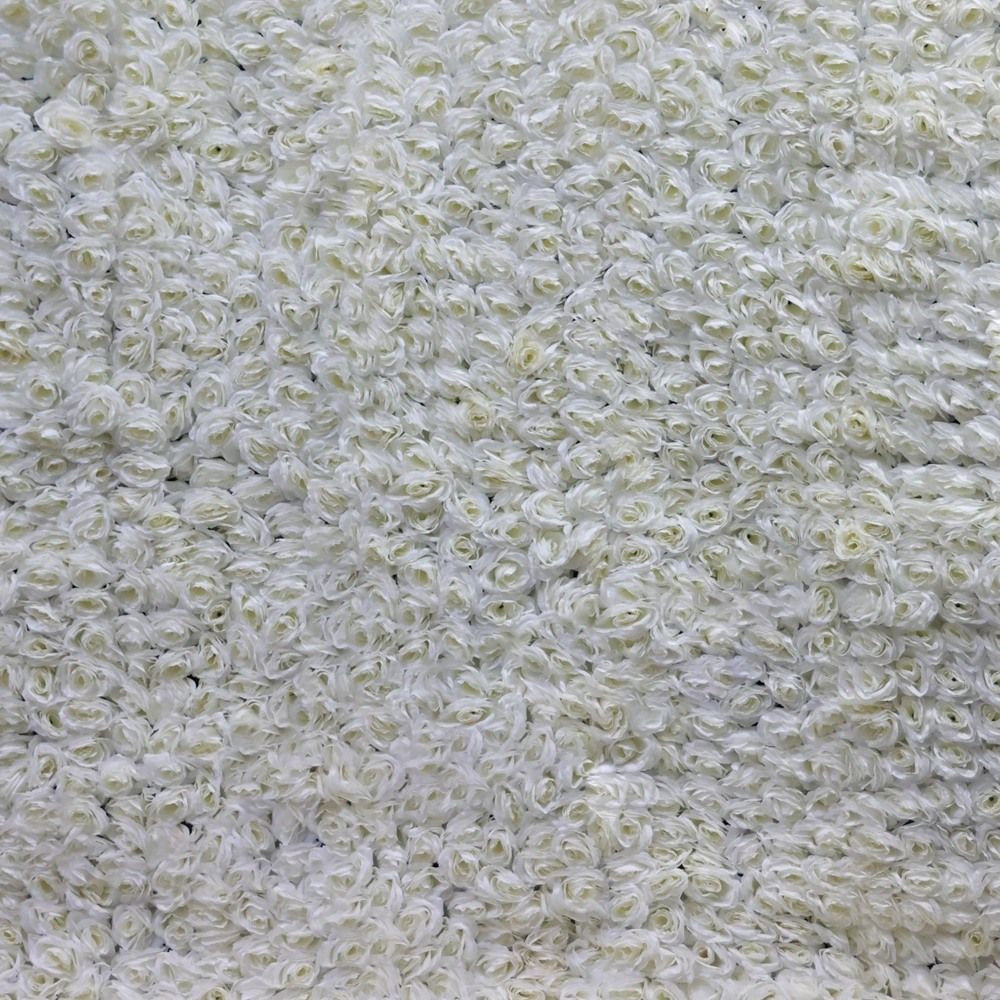 White floral wall composed of many small rose blooms.