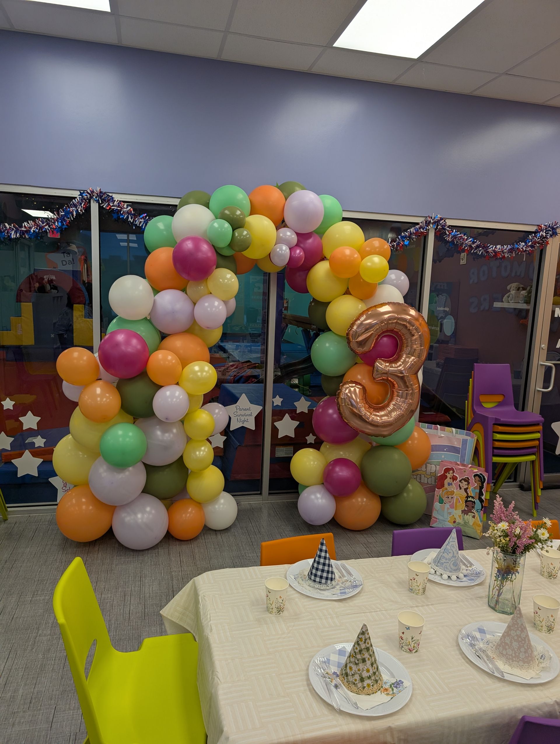 A colorful balloon arch with a number