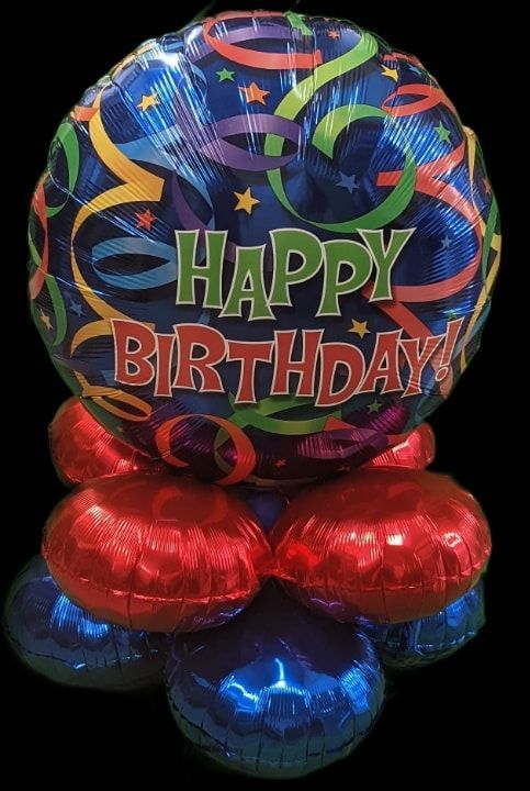 Happy Birthday balloon arrangement, blue, red, and shiny, celebratory.