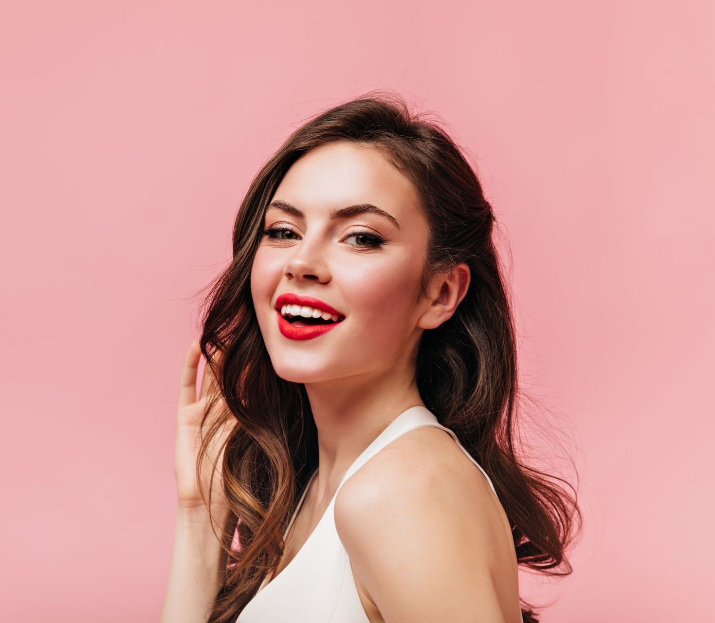 a woman with red lipstick on her lips is smiling
