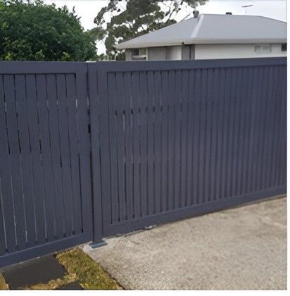 A Blue Fence Is Sitting in Front of A House — Gem Garage Doors in Coffs Harbour, NSW