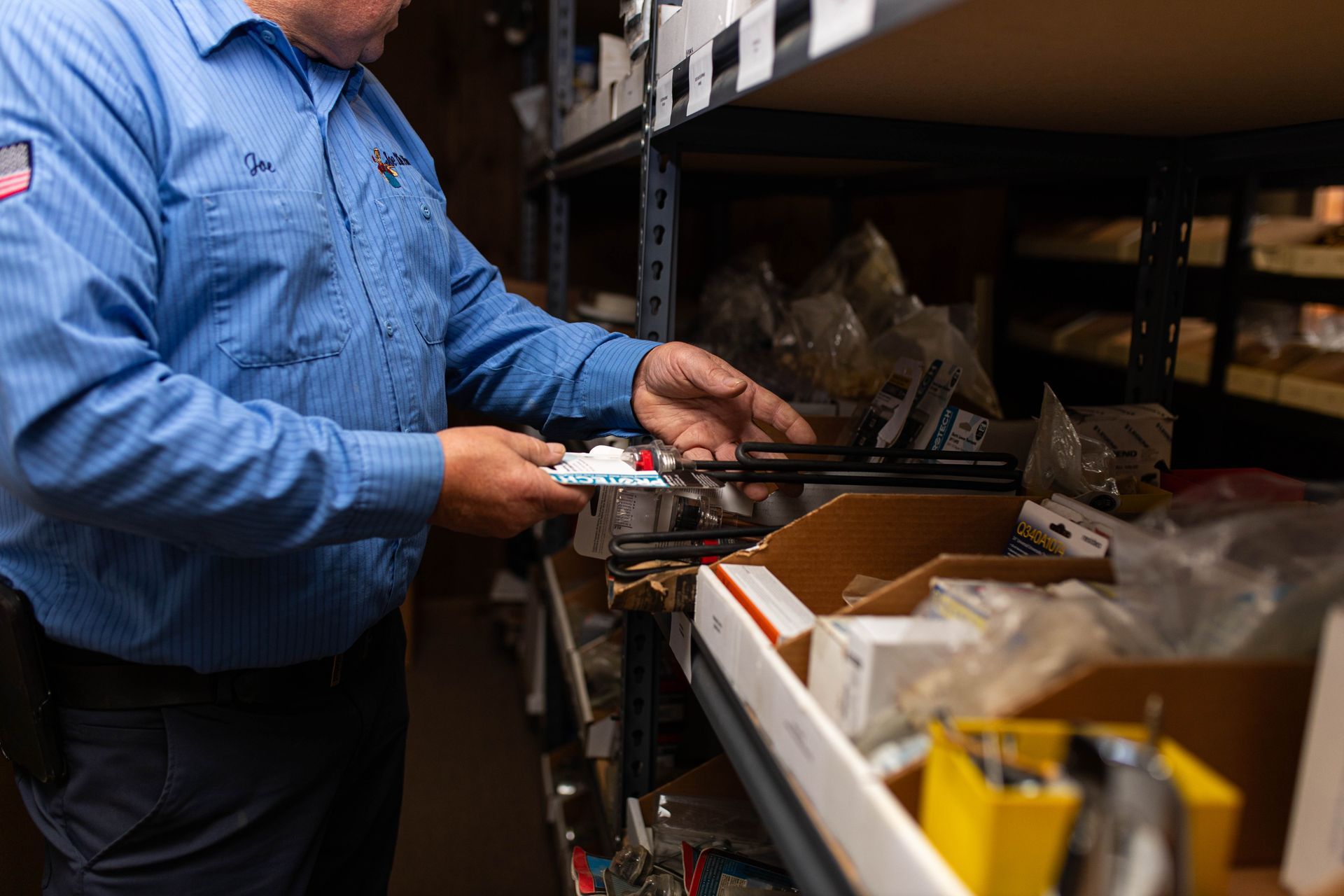 Plumber looking for plumbing parts and equipment in warehouse in Lancaster