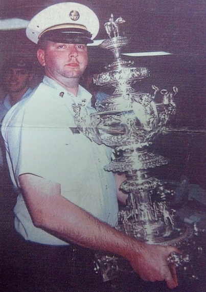 JP Quinn holding a trophy in uniform