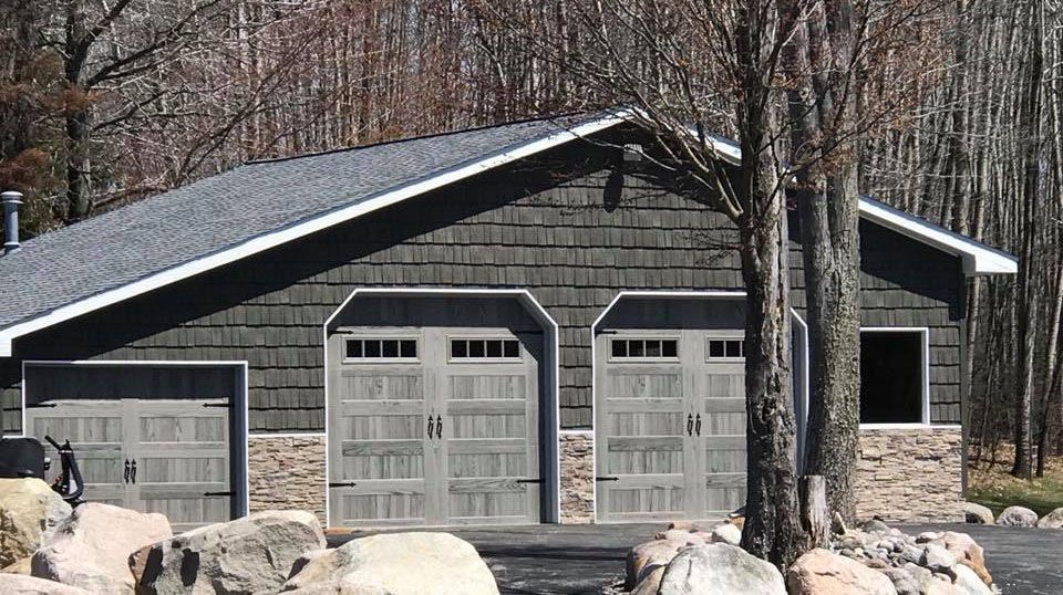 garage with three gray doors