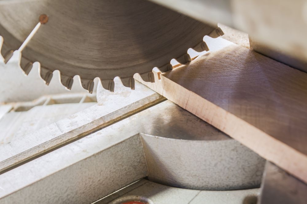 A Circular Saw Is Cutting a Piece of Wood — Border Bolts & Fasteners in Tweed Heads South, NSW