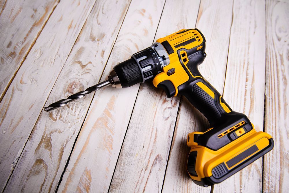 A Cordless Drill Is Sitting on A Wooden Table — Border Bolts & Fasteners in Tweed Heads South, NSW
