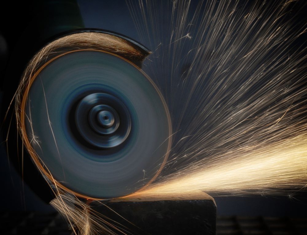 A Grinder Is Cutting a Piece of Metal — Border Bolts & Fasteners in Tweed Heads South, NSW