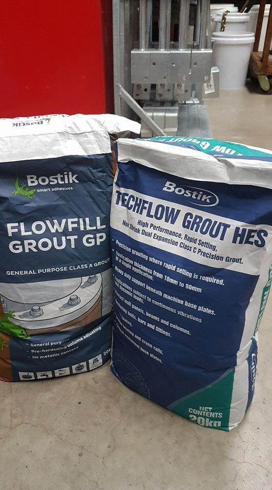 Two Bags of Grout Are Sitting Next to Each Other — Border Bolts & Fasteners in Tweed Heads South, NSW