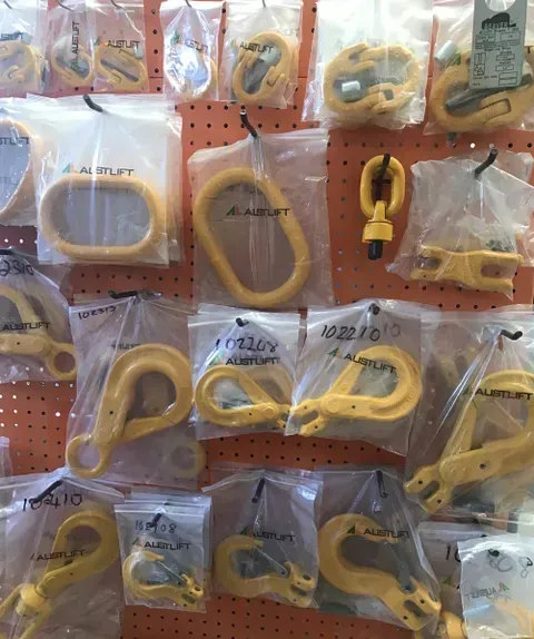 A Bunch of Yellow Hooks Are Hanging on A Wall — Border Bolts & Fasteners in Tweed Heads South, NSW