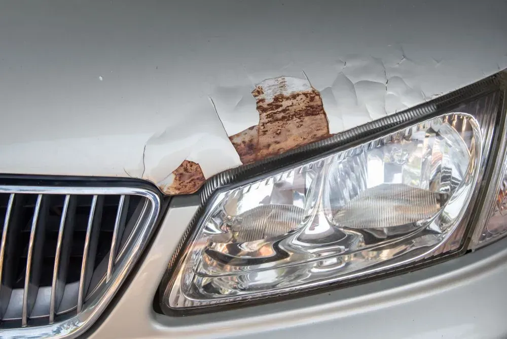 Close-up of a Silver Car With Severe Paint Peeling and Rust Damage on the Hood — Coastal Collision Repairs in Buderim, QLD