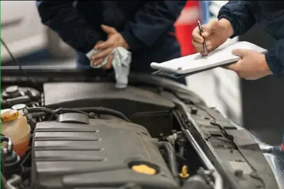 Mechanics Inspecting a Car Engine; One Writes on a Clipboard — Coastal Collision Repairs in Buderim, QLD