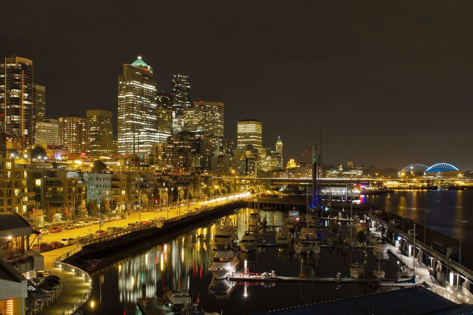 downtown Seattle commercial buildings at night. They are bright because of commercial electrical contractors