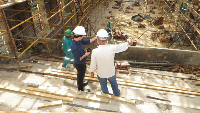 Two men on site working out choosing a new electrical company for their construction project