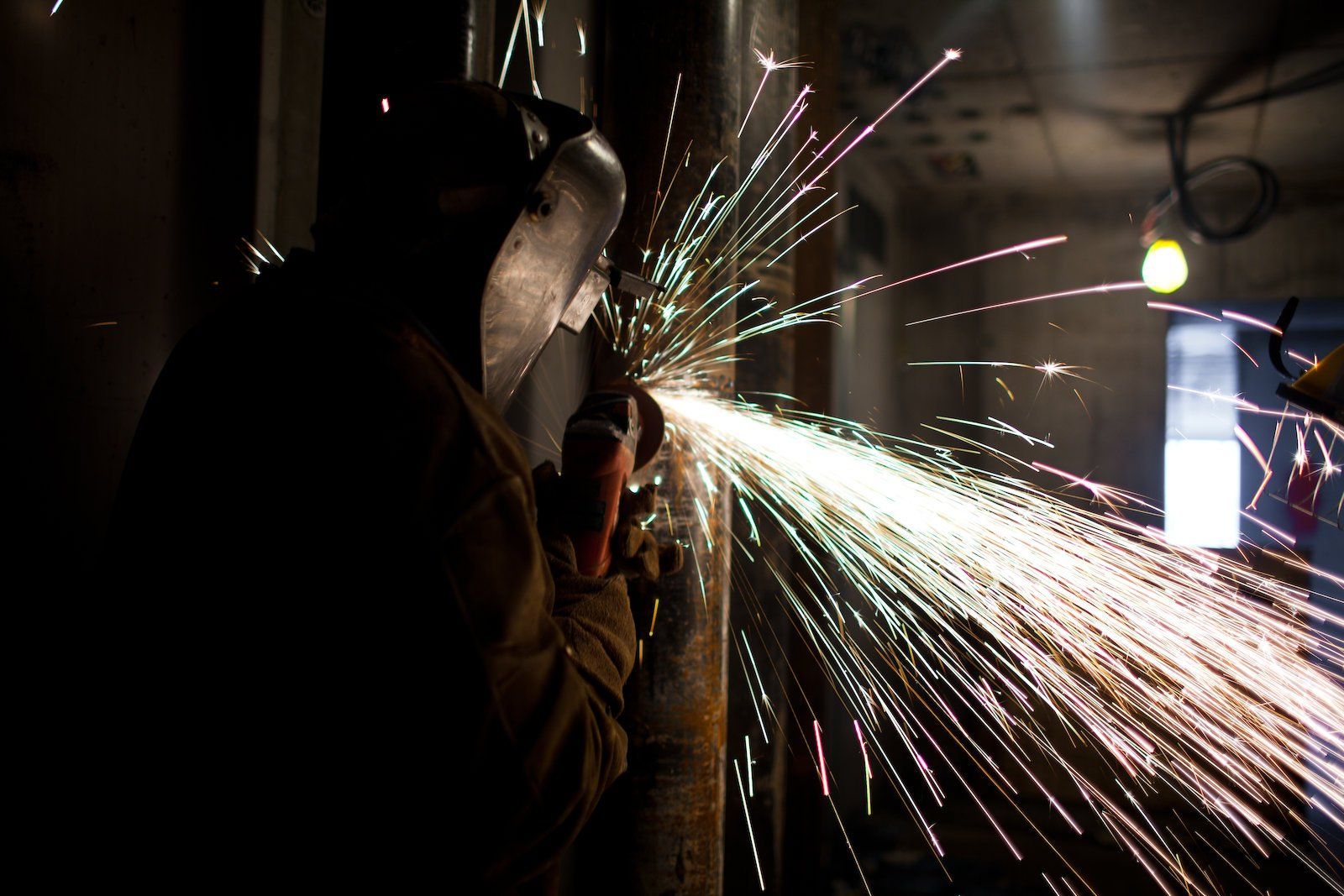 worker using a orbital sander