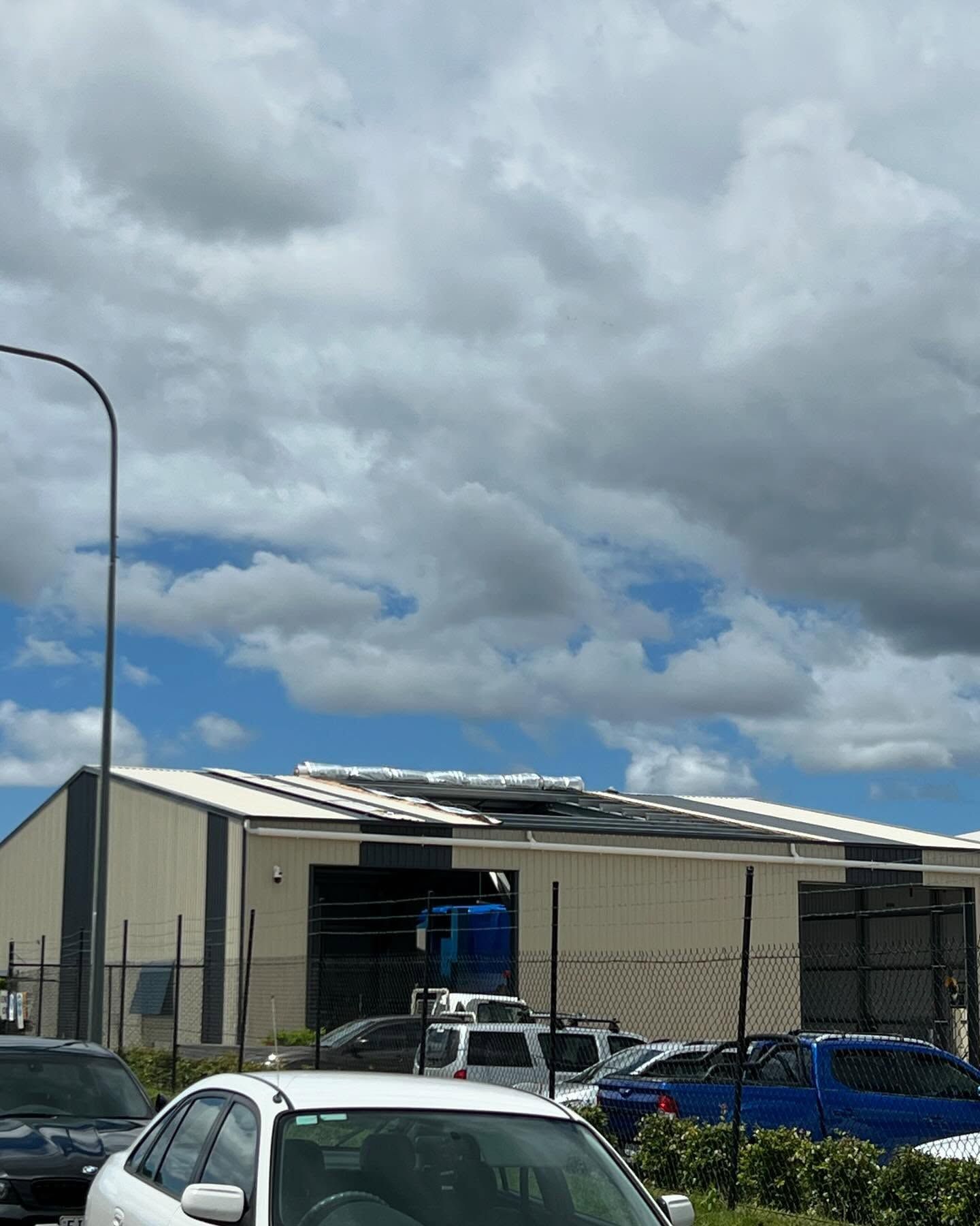 A Lot of Cars are Parked in Front of a Building — Mbah Metal Roofing in South Brunswick Heads, NSW